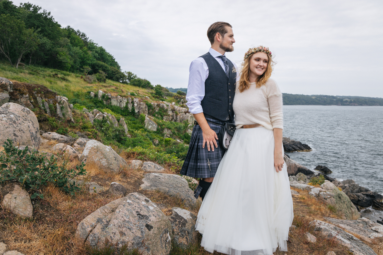 A couple on the cliffs of the Danish island where they had their adventure elopement and got married abroad in Scandinavia