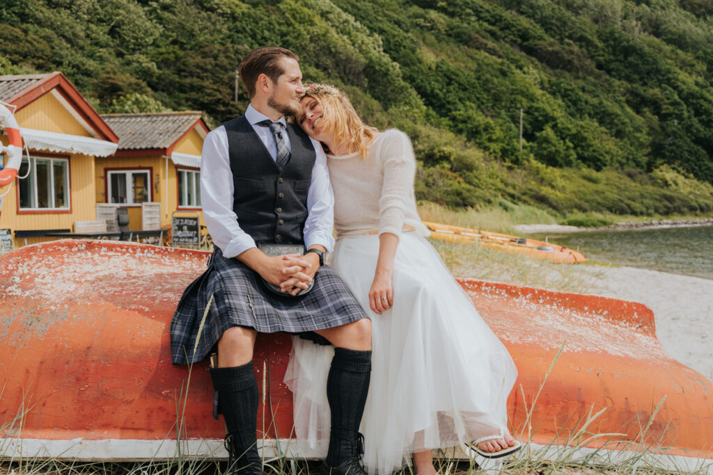 A couple sitting on the boat and enjoying their island elopement in Europe.