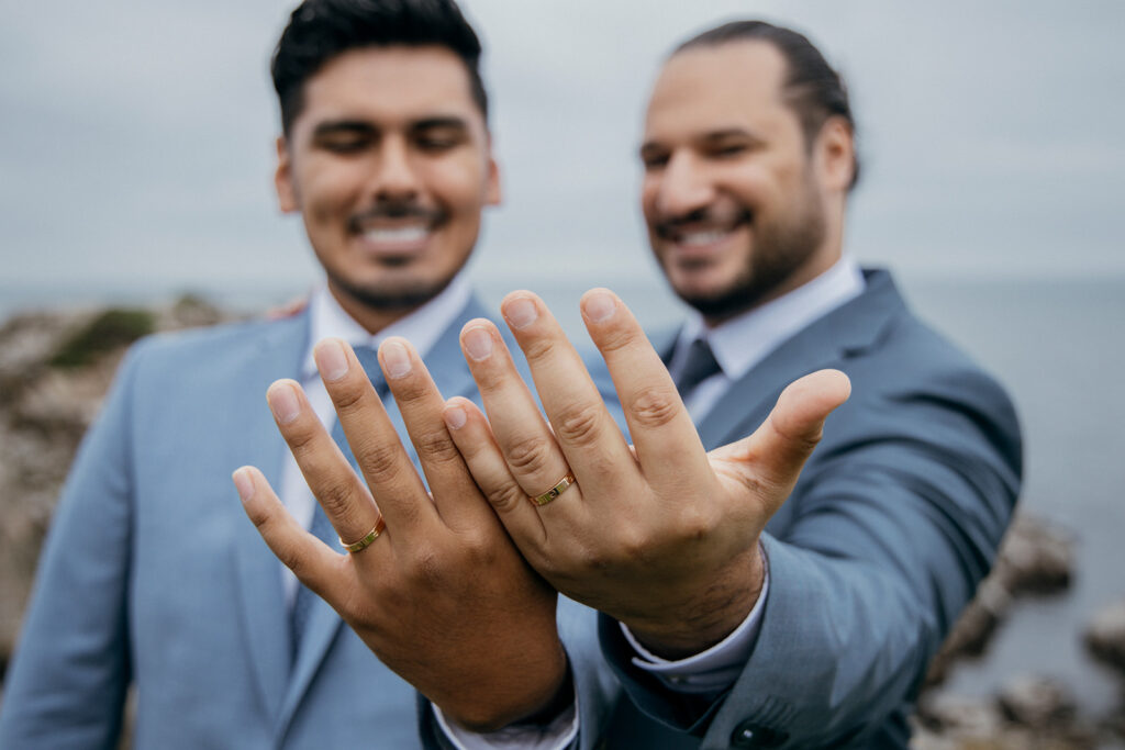 LGBT couple is showing their rings after romantic gay wedding in Denmark in Bornholm island.