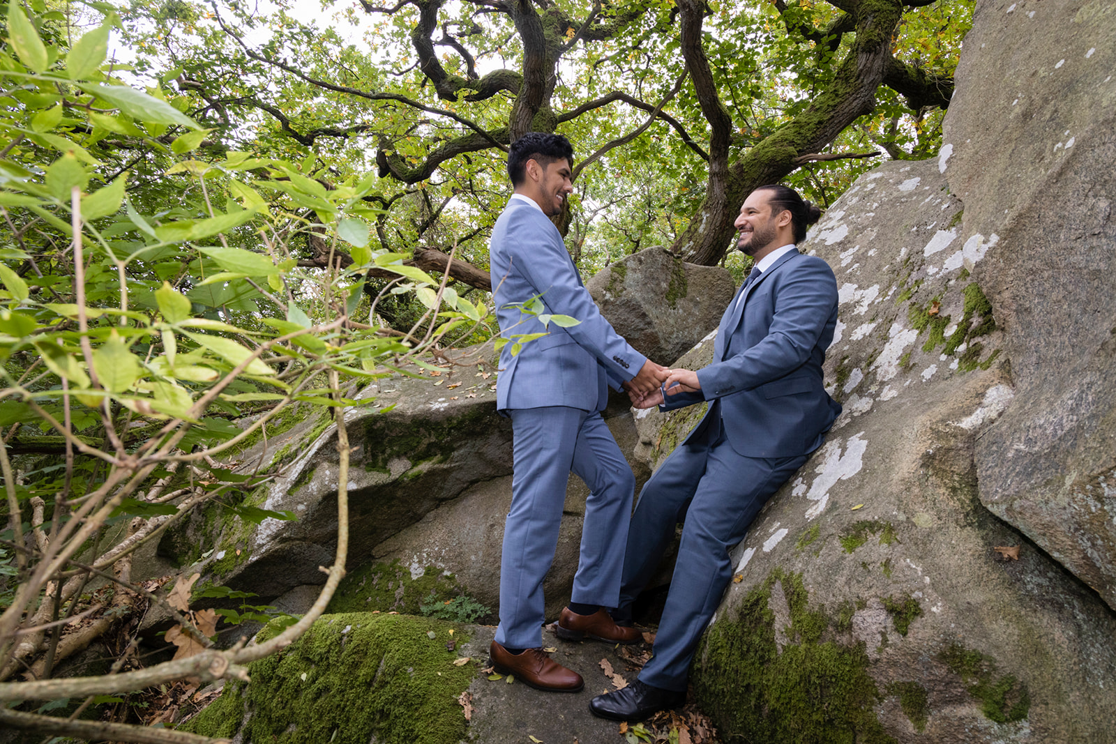 A gay couple by the huge rock on Bornholm island, the easiest country for getting married for same sex couples.