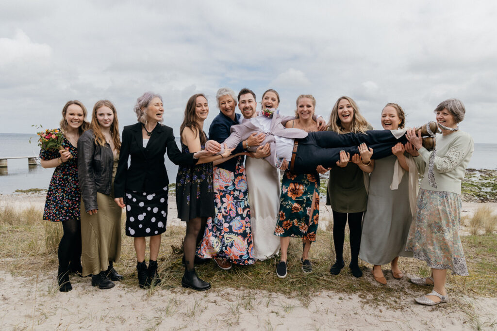 A group of guests having fun at the intimate destination wedding in Bornholm