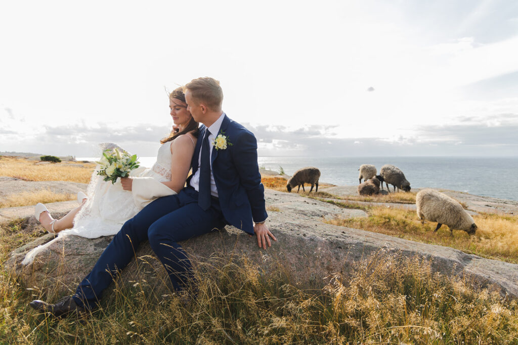 A couple embracing in the meadow during their adventure elopement abroad in Bornholm