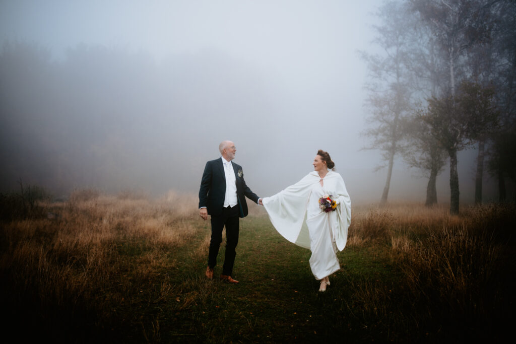 A photo of the wedding couple walking in the meadow on Bornhom island.